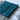 Two swatches are laid on top of each other in teal and grey. Next to them are a pair of snips and some pins.