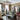 Photo of TitiTyy yarn shop. Its a bright, warm looking shop with rustic furniture, a plush sofa and a large chandelier in the centre of the room. There is beautiful yarn in every colour all over the room.