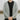 Close up of a man wearing a grey, hand knitted, v-neck cardigan on black t-shirt and jeans | Lowther Fingering Cardigan Knitting Pattern