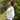 Women standing in the countryside, in a cream roll neck sweater