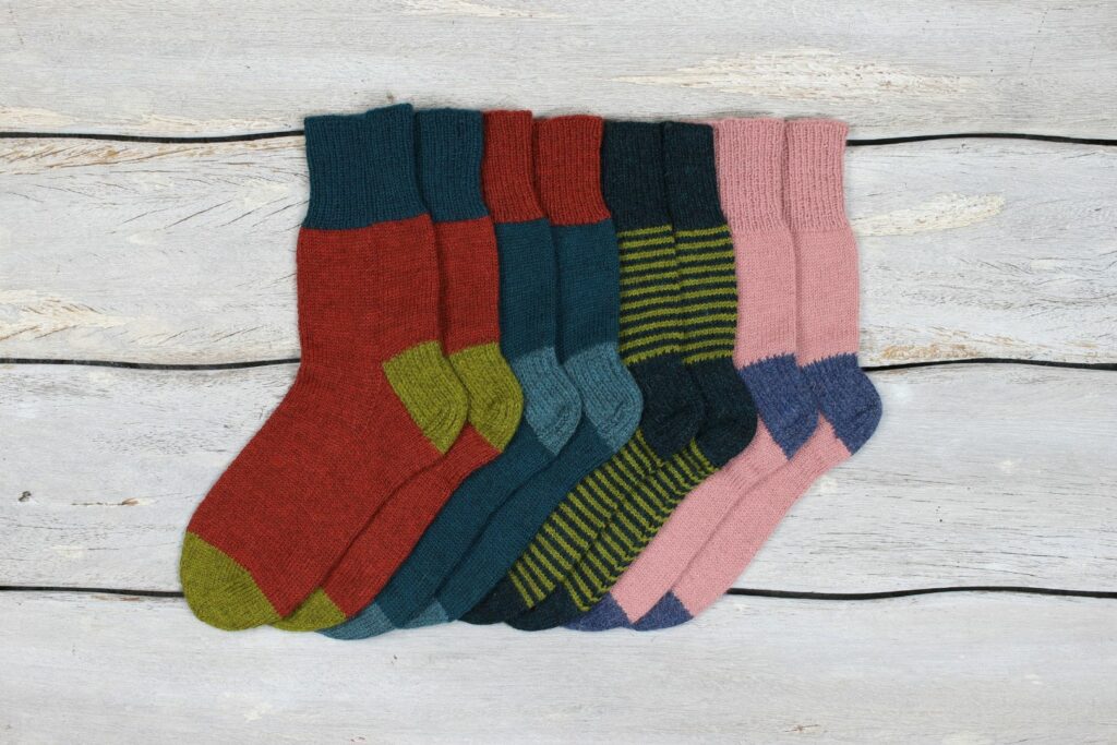 Variations of the One Sock knitting pattern by Kate Atherley in The Fibre Co. Amble yarn.